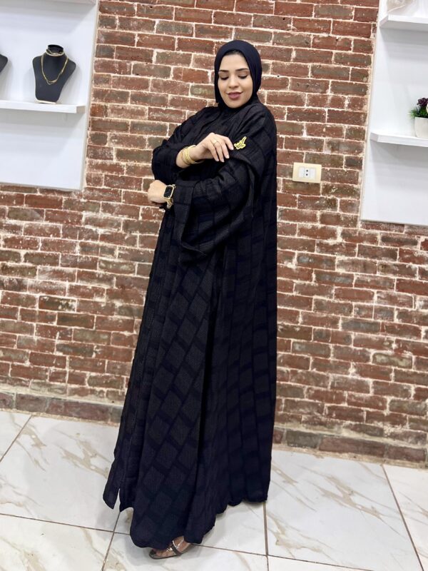 Woman in black traditional attire.