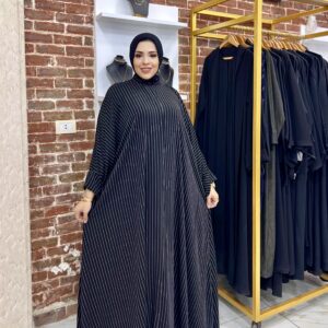 Woman in striped black abaya dress.