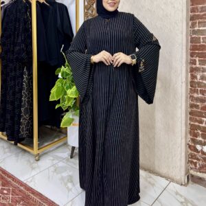 Woman in stylish black striped dress.
