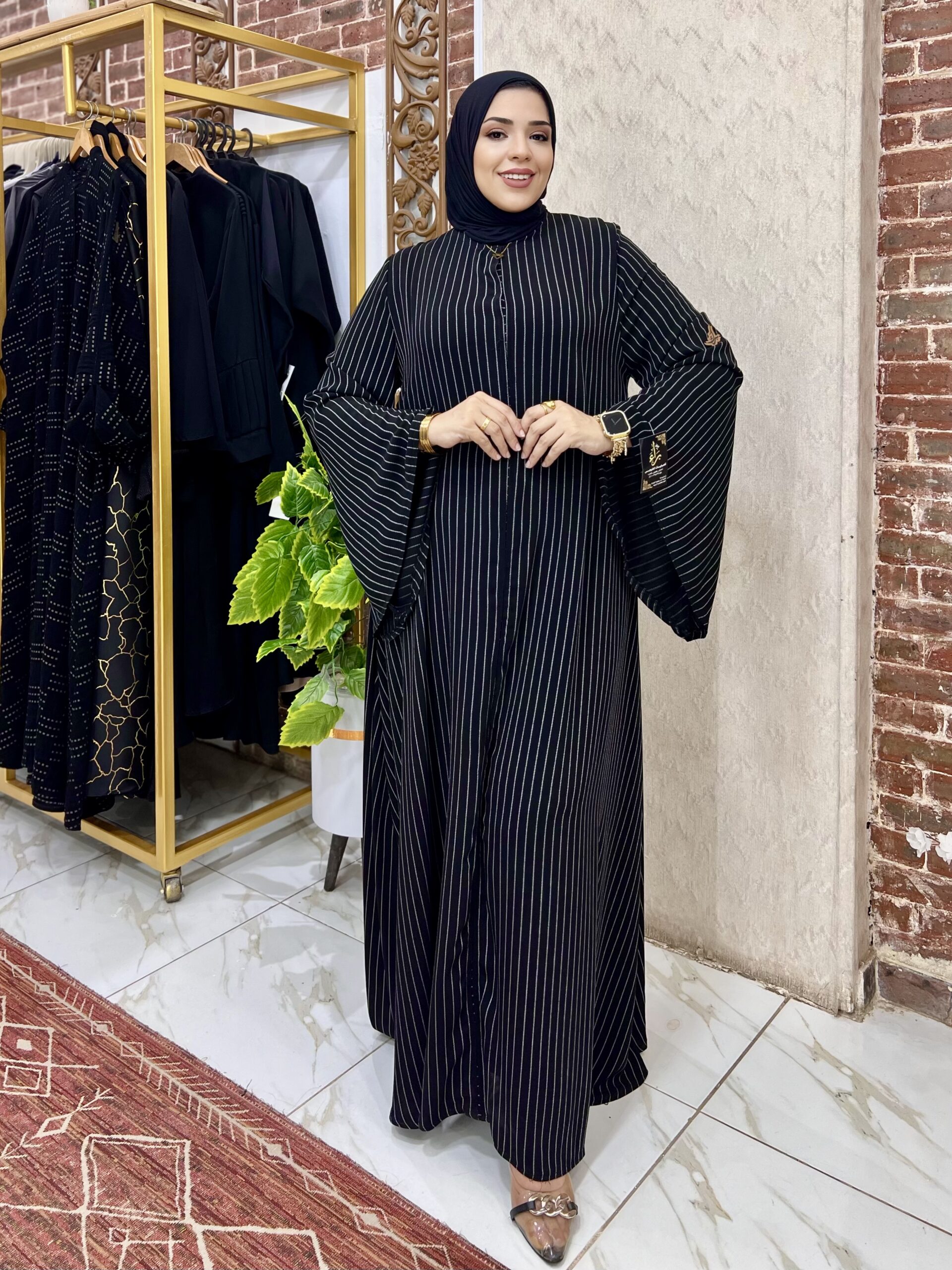 Woman in stylish black striped dress.