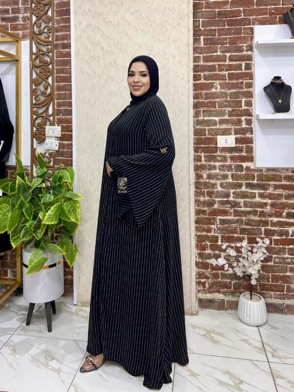 Woman in black striped abaya.